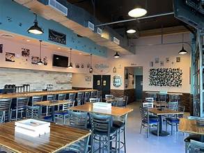 DiBella’s dining room with tables and bar seating