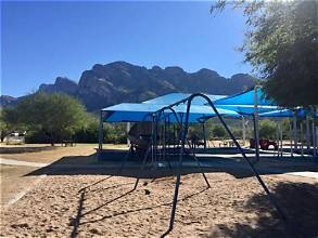 Shaded playground with mountain views at James D. Kriegh Park